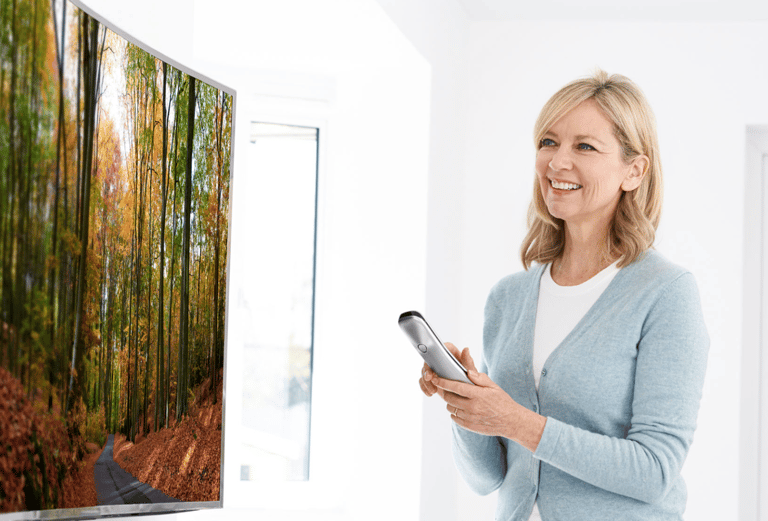 a woman holding a remote control control device