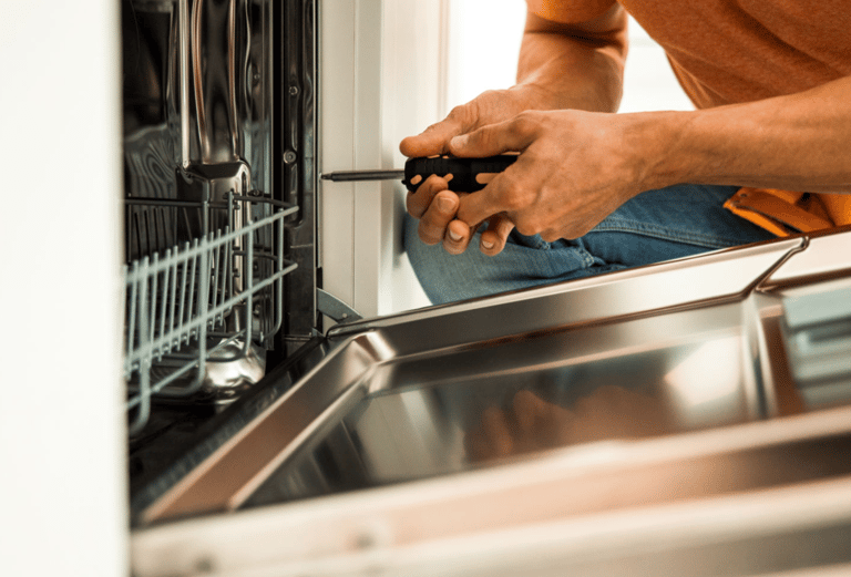a man in a orange shirt is holding a screwdriver