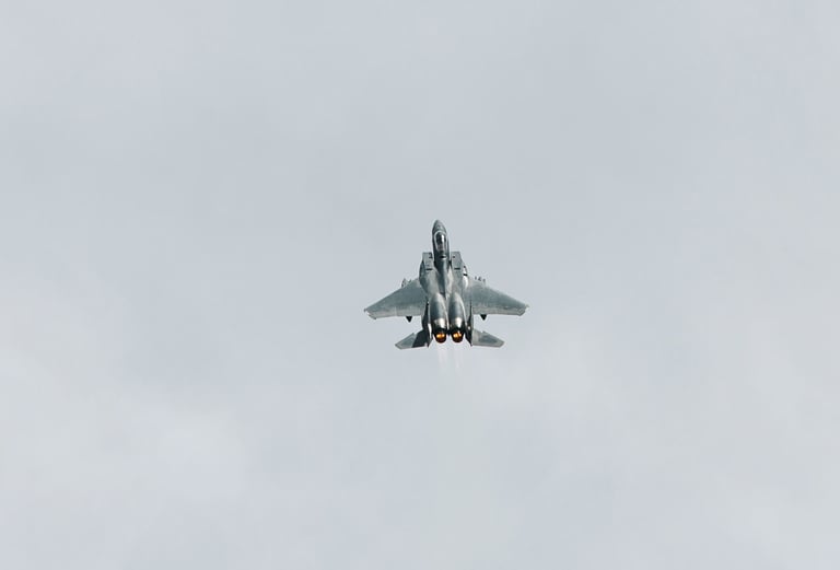 a fighter jet flying through the sky f-16