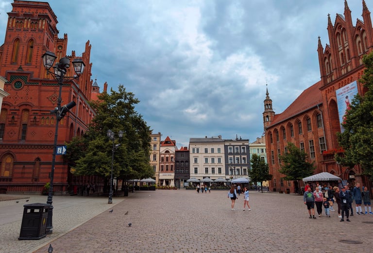 Medieval old town square in Toruń with red-brick buildings