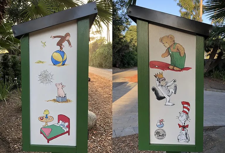 Hand-painted Little Free Library featuring Curious George, Corduroy, and the Cat in the Hat.