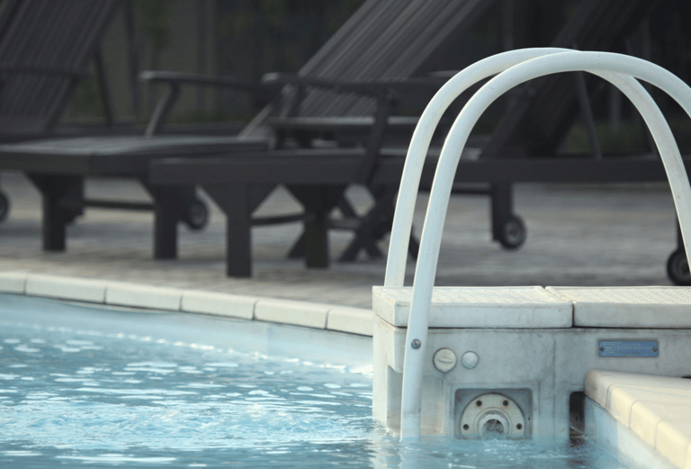 a pool with chairs and chairs and a swimming pool