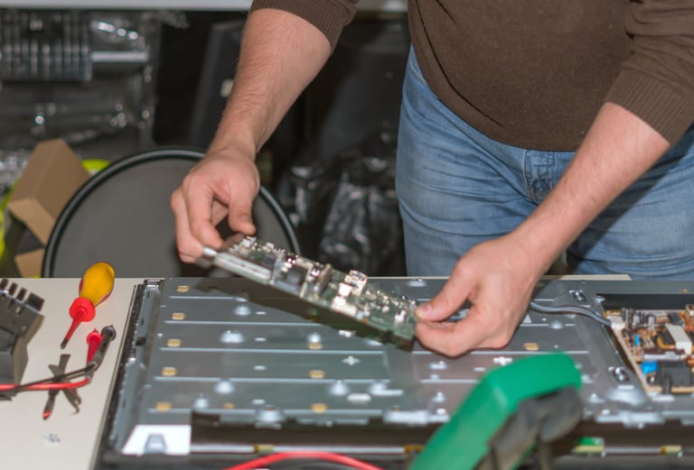 a man is holding a piece of electronic equipment