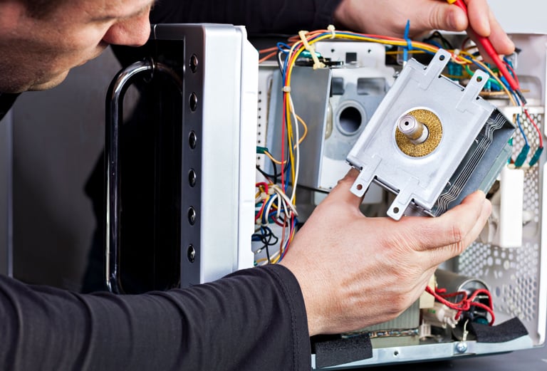 a man is fixing a computer monitor in a computer