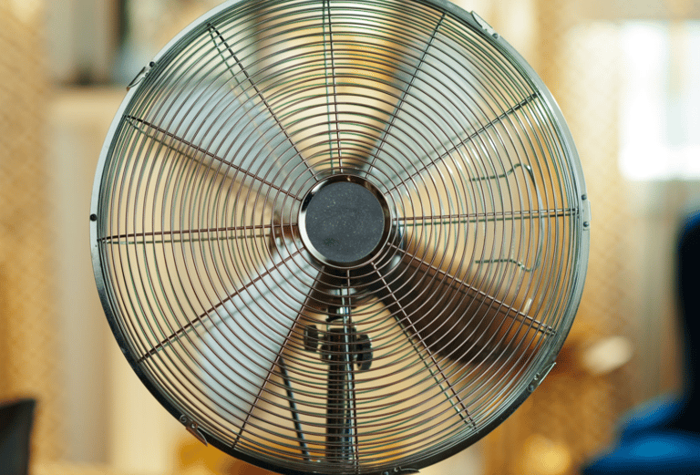 a fan on a table top with a chair