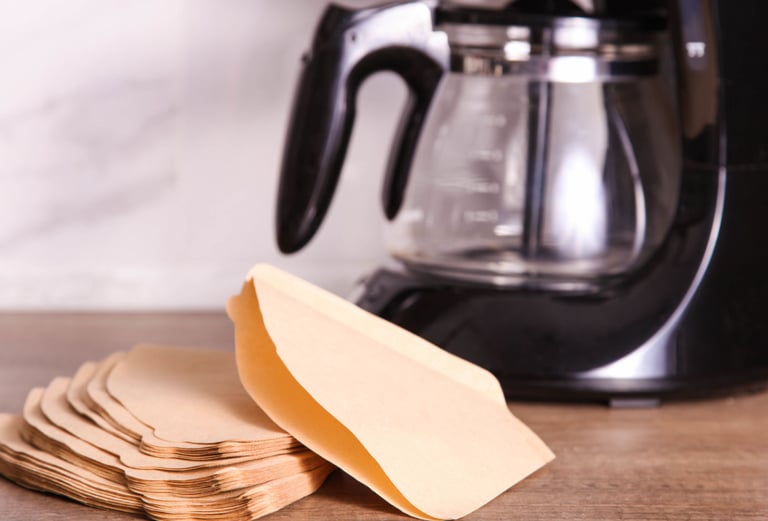 a coffee maker with a paper bag on a table