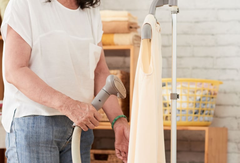 a woman in a white shirt is holding a vacuum