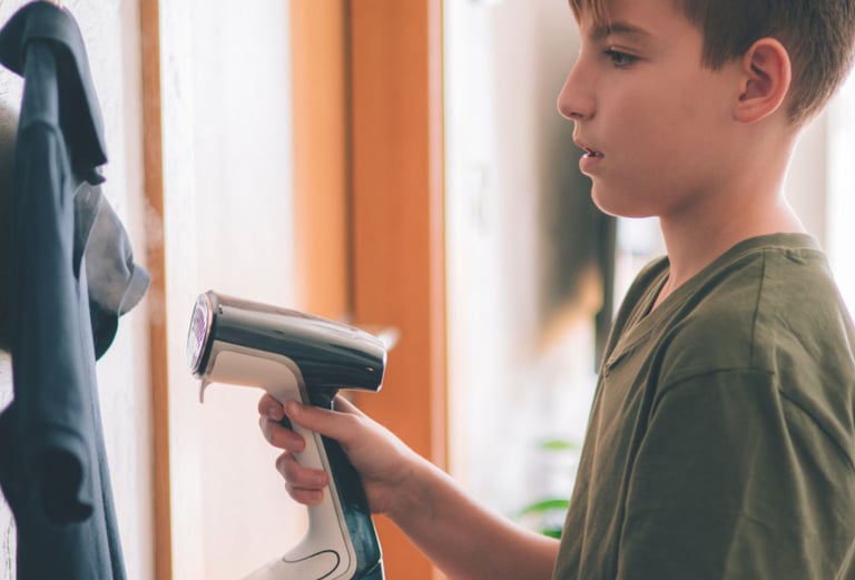 a boy is holding a hair dryer