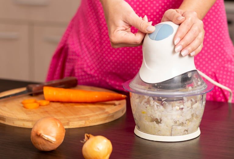 a woman is holding a blender in her hands