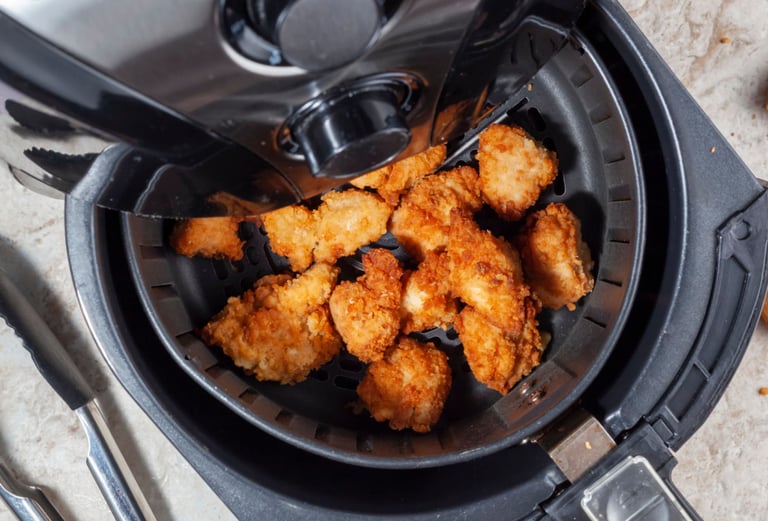 a fryer with chicken nuggling in it