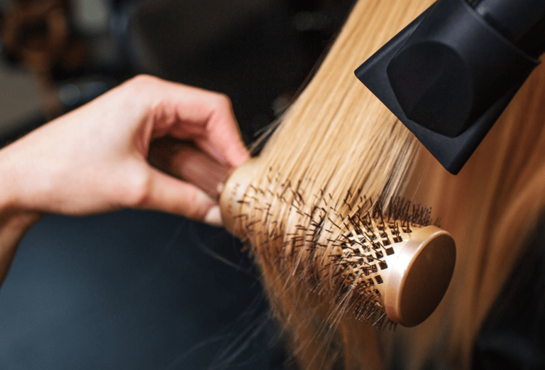 a woman is brushing her hair with a brush
