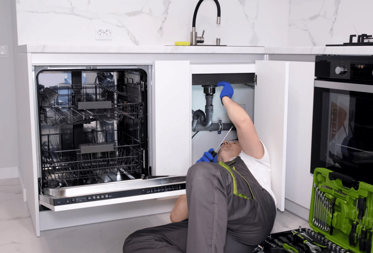 a man in a kitchen with a dishwasher and a dishwasher