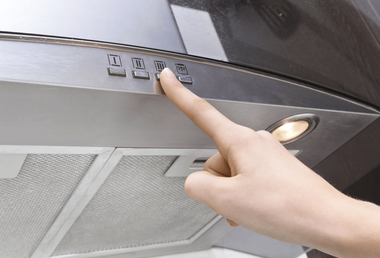 a person pointing at a stove top oven