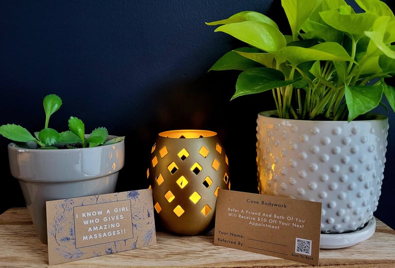 Monthly discount cards nestled amongst warmly lit candles and green plants