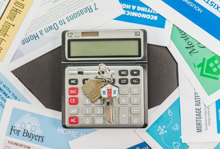 mortgage papers all around a calculator and house keys for homebuyers