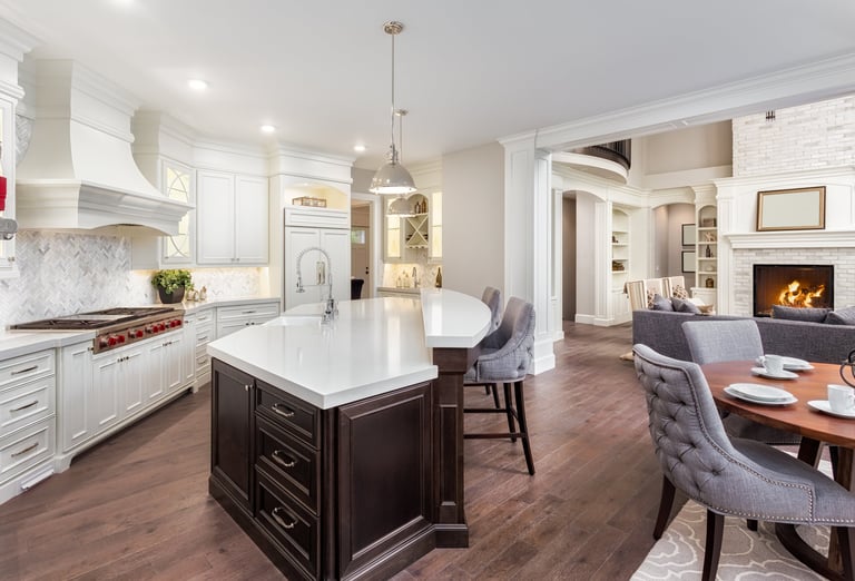 Newly built kitchen featuring custom cabinetry, countertops, flooring, and lighting