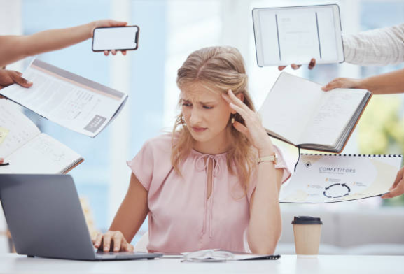 overwhelmed woman at desk