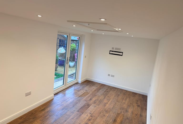 Inside converted garage with French doors and spotlights