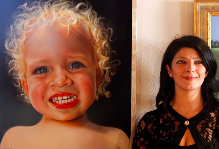 The artist Selen Cinus posing next to one of her paintings