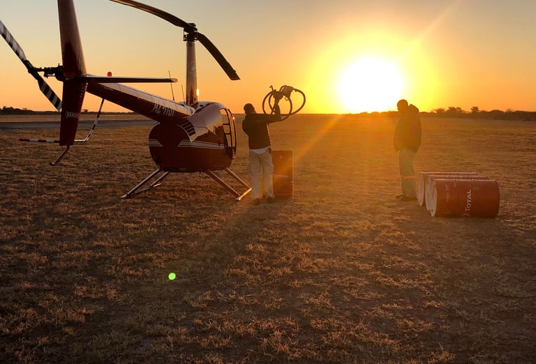 refueling the helicopter in a setting sun