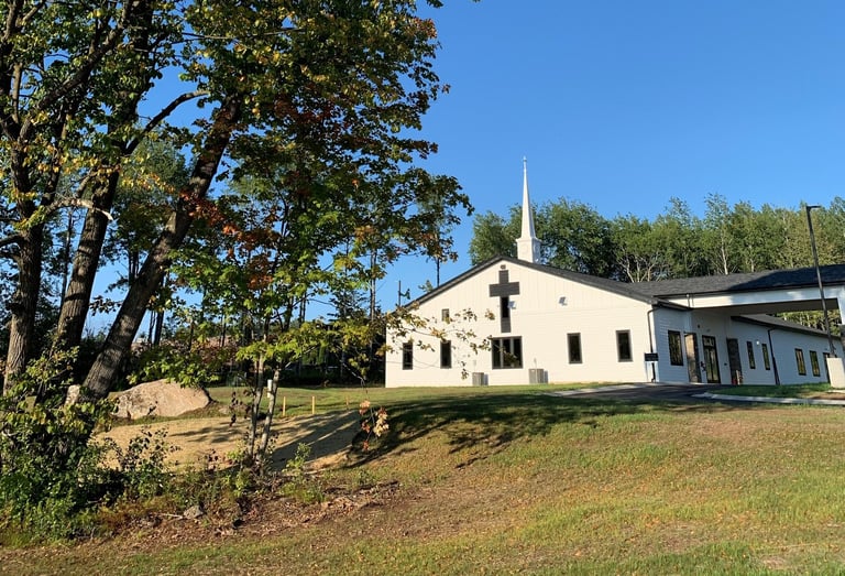 New Life Lutheran church building, steeple, and tree
