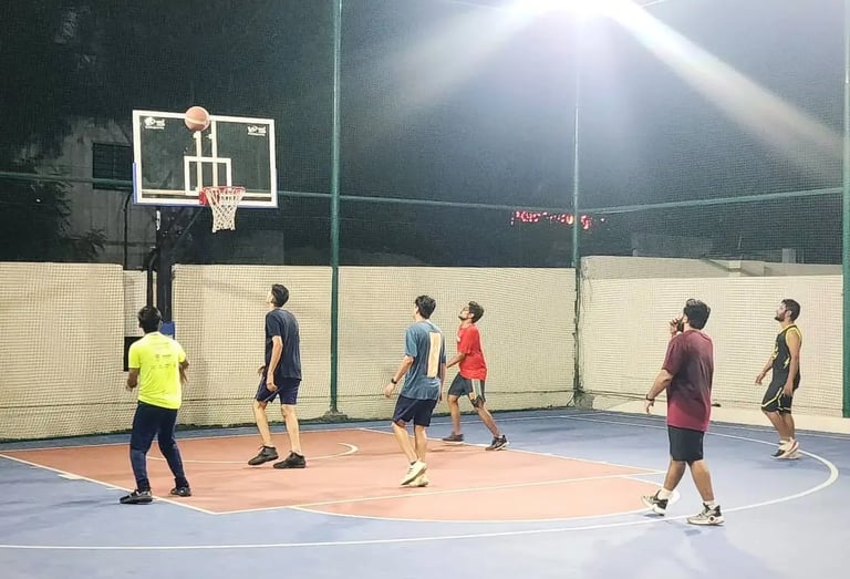a group of people playing basketball on a court