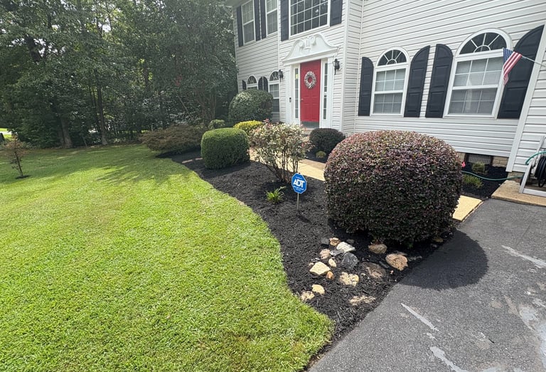 Mulch and decorative rock bed installation with custom flower bed design and edging for a Southern M
