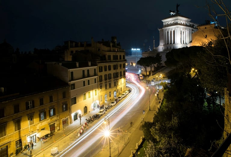 Rome at night with illuminated historic buildings and streetlights