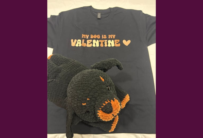 a tshirt that says "my dog is my valentine" with a stuffed rottweiler on top of it