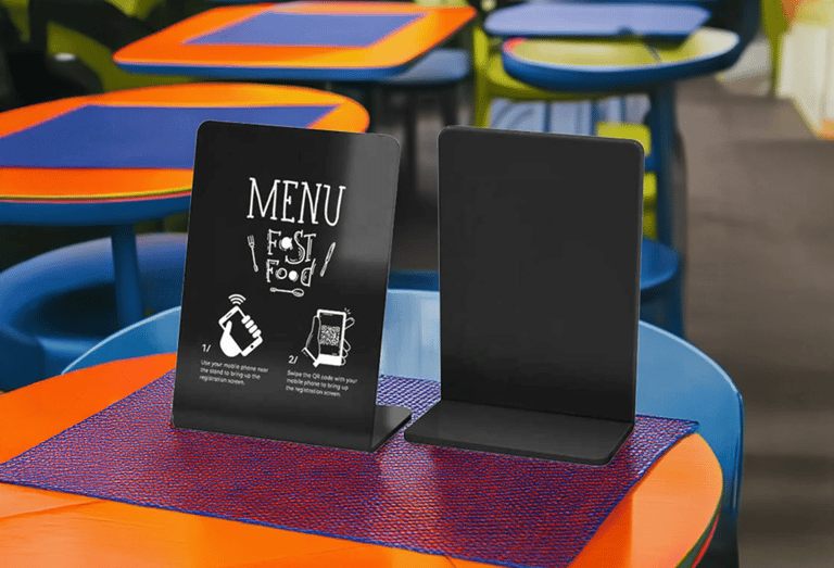 Small NFC display stand on table of a fast food restaurant, showing menu and promo content.