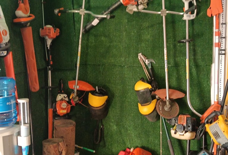 Professional Stihl chainsaws and garden power tools organized on a green grass wall display.