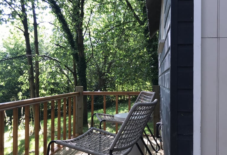 Relax on the balcony at Tom's Hut.