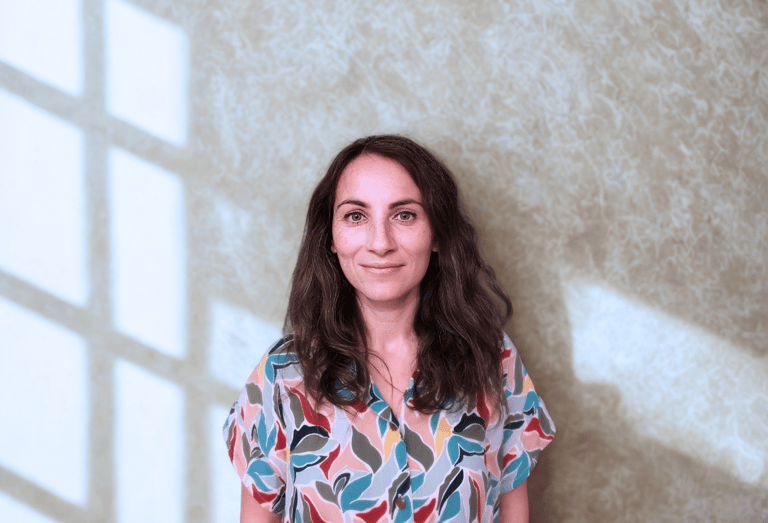 a woman in a colorful shirt and jeans