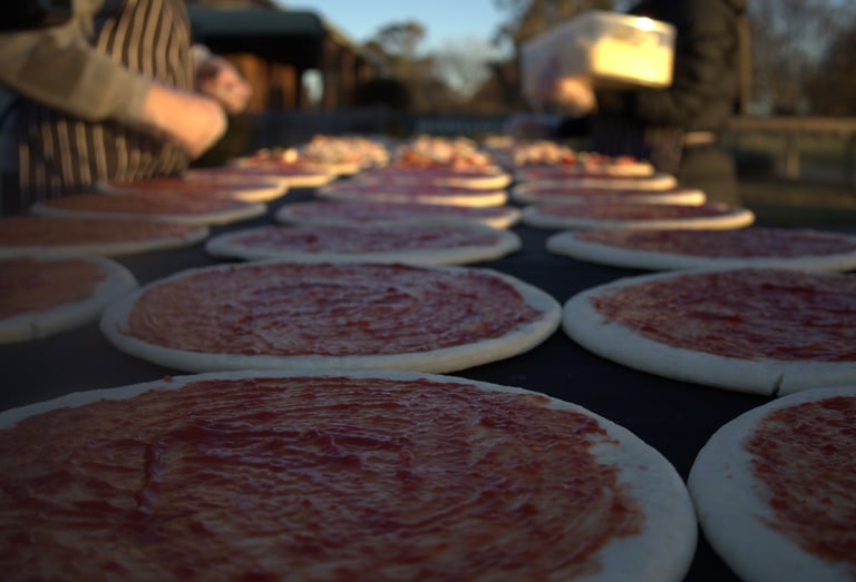 Pizzas being prepared on a table at a party in country Victoria