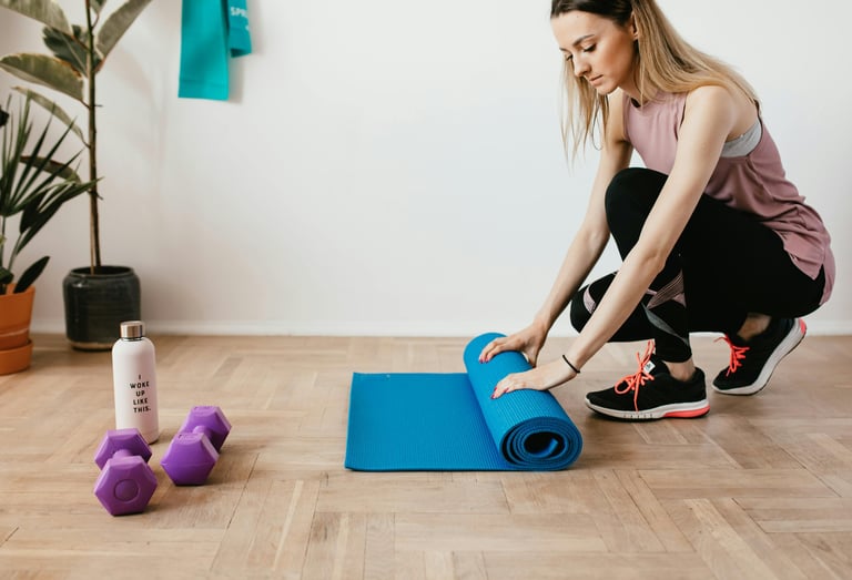 a woman is sitting on a yoga mat with a blue yoga mat