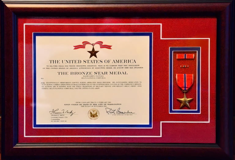 Framed Bronze Star Medal certificate and military award for service in Iraq with red and blue matting.