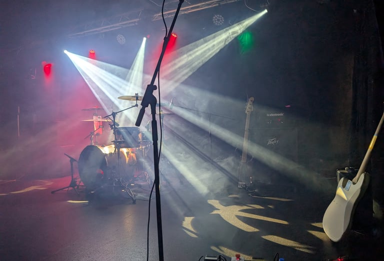 Professional stage lighting and PA setup for a Mosaic live performance at a marquee wedding