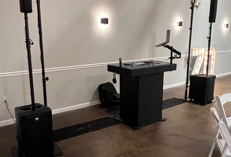 Professional mobile DJ setup with black podium, sound system speakers, coumbia sc
