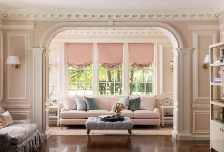 a living room with a couch and a ottoman