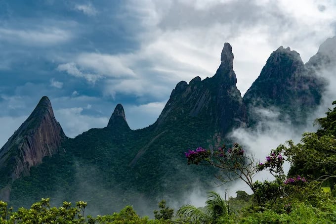 Pico Dedo de Deus em Teresópolis com nuvens baixas e vegetação nativa da Serra dos Órgãos.
