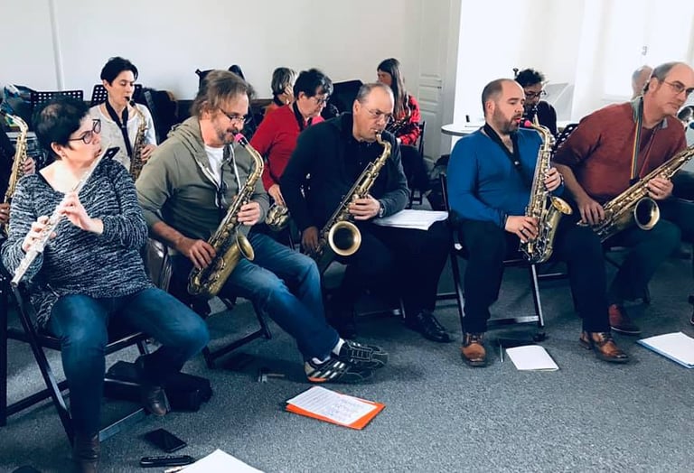 a group of people sitting in chairs playing instruments
