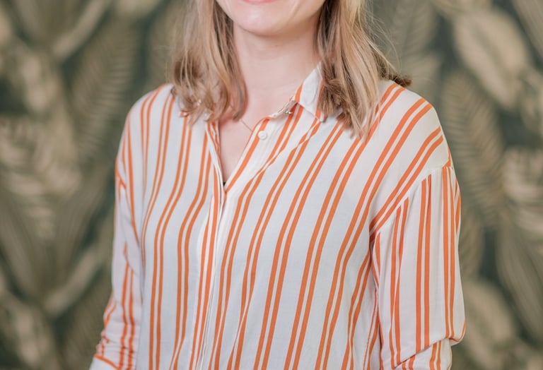 a woman in a striped shirt and jeans