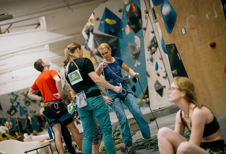 climbers in a climbing wall are checking the rope
