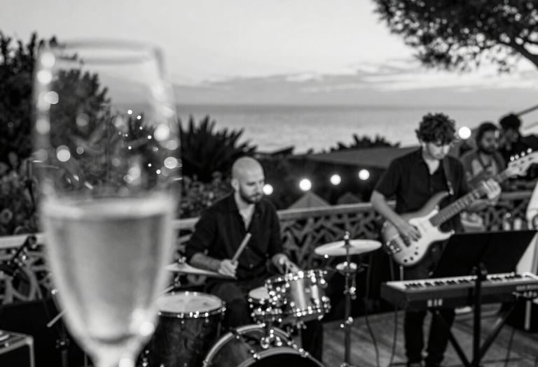 A softly lit hotel lounge with a string duo performing, bathed in warm golden light and surrounded by elegant ivory décor.