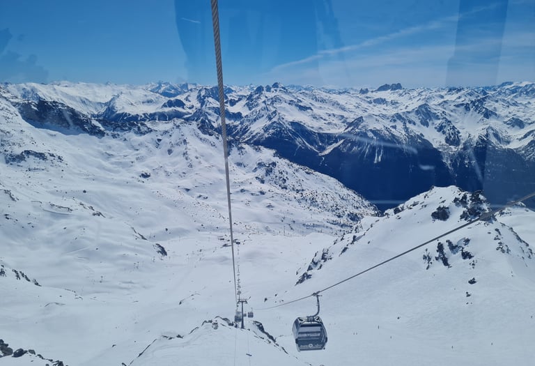 View of ski lifts and snowy slopes in the Val Thorens 3 Valleys ski area