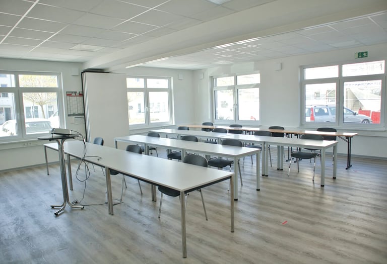 Feltec Paderborn a room with a table and chairs and a whiteboard
