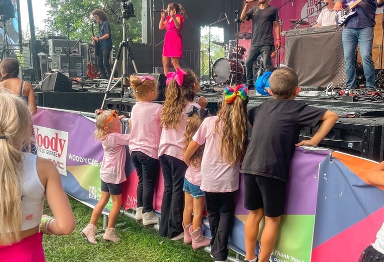 LuxeBand performing at an outdoor festival for an audience of children