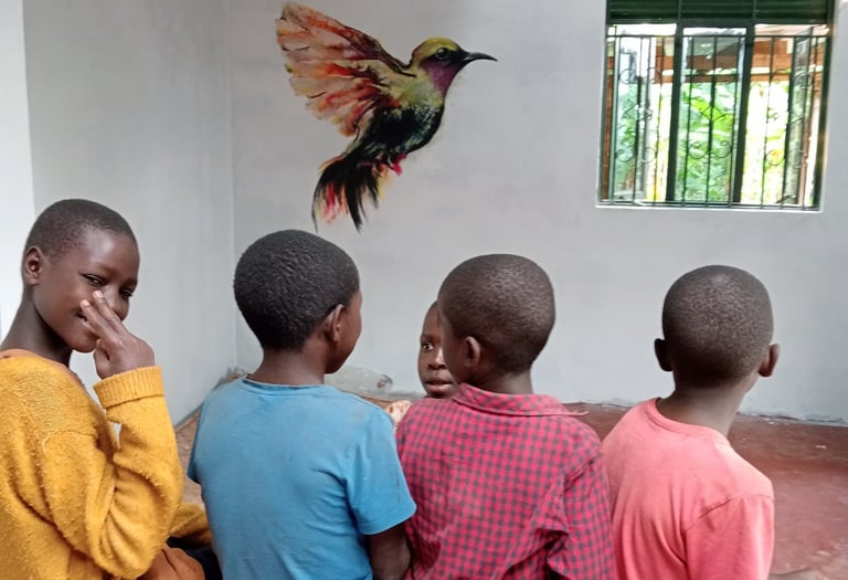 Image of 4 children in front of bird mural, with one looking back at the camera.