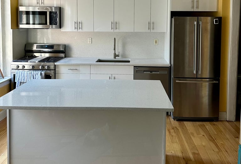 a kitchen with a stainless steel refrigerator and a refrigerator