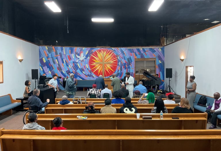 a group of people sitting in a church with a pulpit